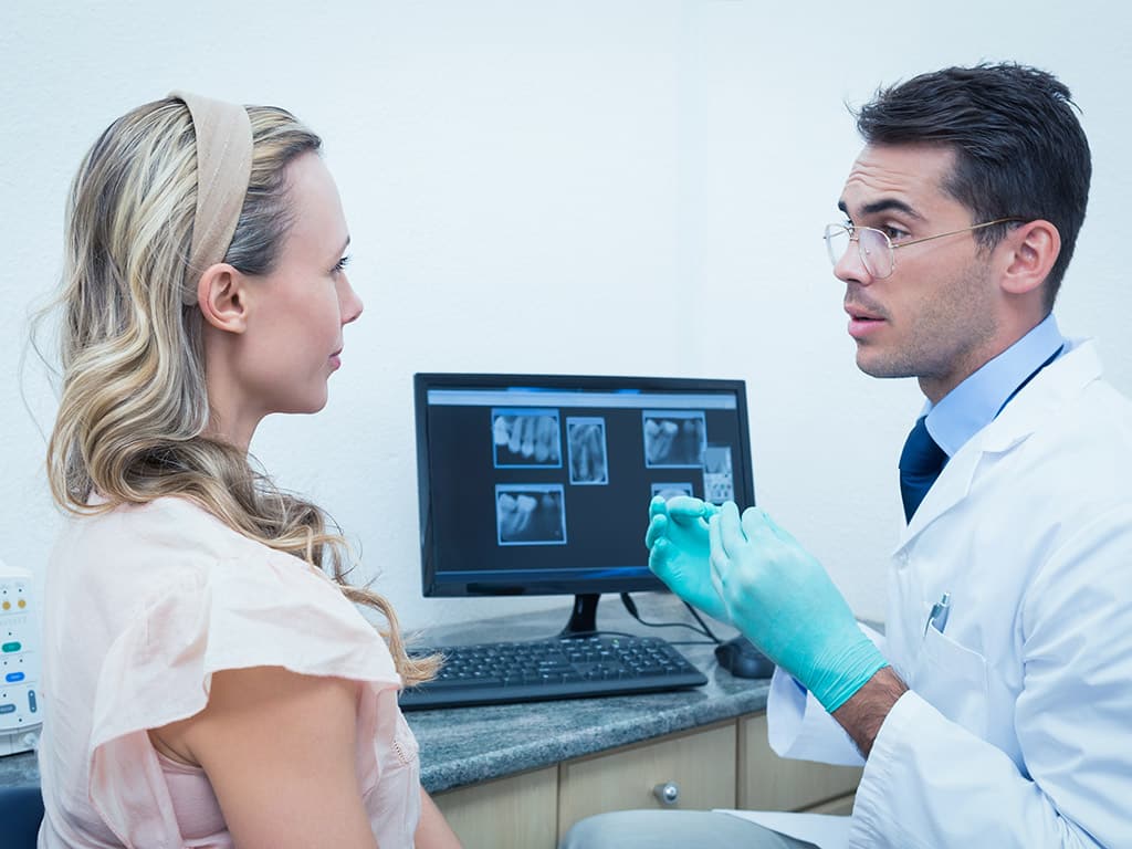 Dentist consulting with his patient